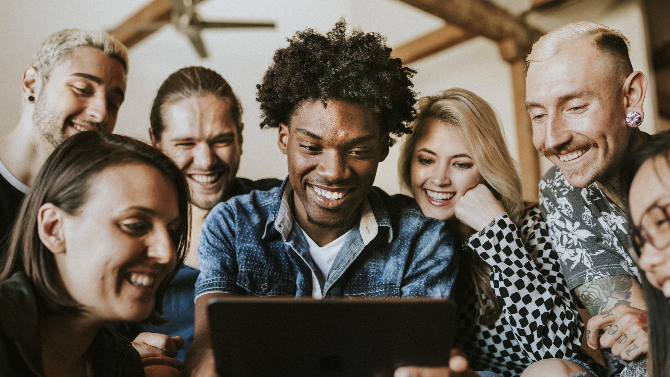 Diverse people using a digital tablet together Diverse people using a digital tablet together